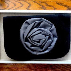 Black clutch with large grey flower.